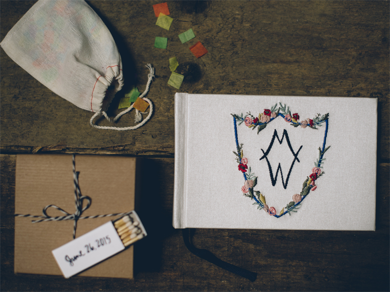  Above: more wedding details incorporating my illustrations- on the left, matchbooks printed with the hand-lettered wedding date, and on the right a beautiful guest book hand-embroidered with the crest I illustrated for Danielle and Brad. Image by  Lelia Scarfiotti.  