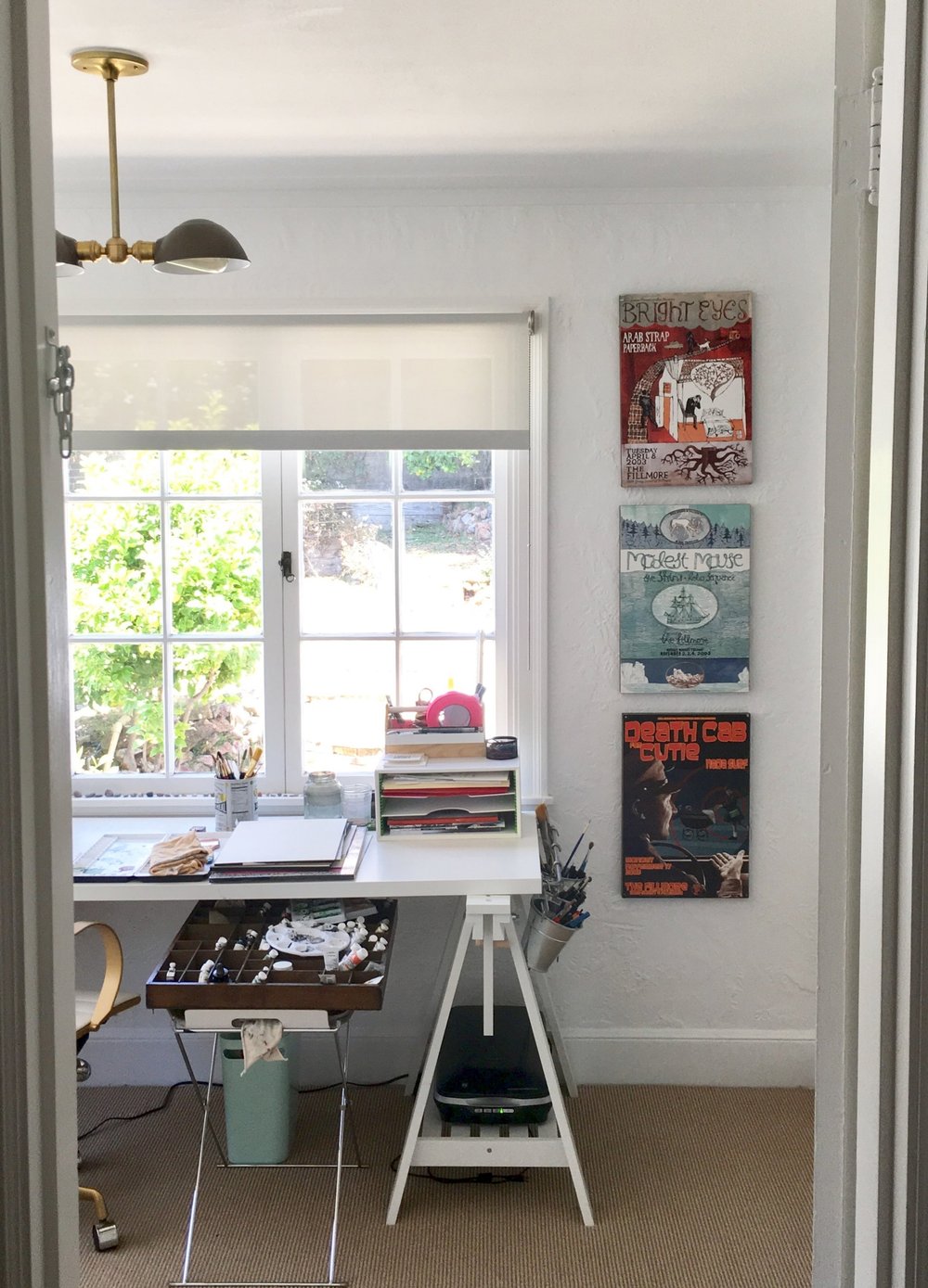  Looking in from the hallway we made when we separated this sun room from the bedroom. I use a lot of hot pink artist's tape. And I use a vintage letterpress tray to keep my paints (semi) organized. We collected the posters from concerts at the Fillmore over the years. 
